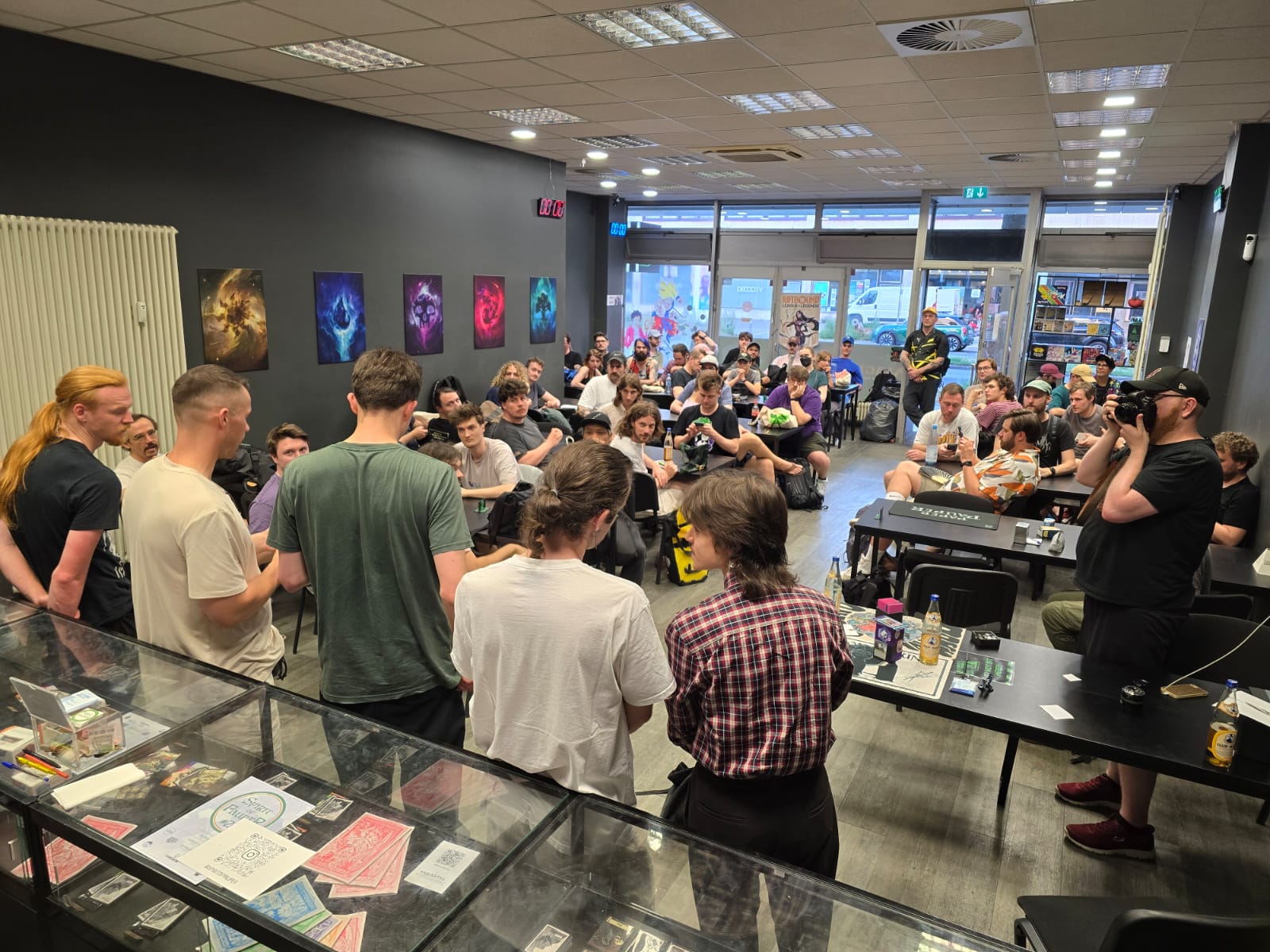 A packed tournament room at Mana Games with players at the tables
